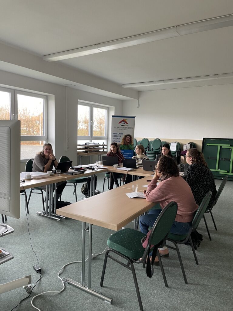 Partners working together at tables in a meeting room during a transnational project meeting in Schwerin